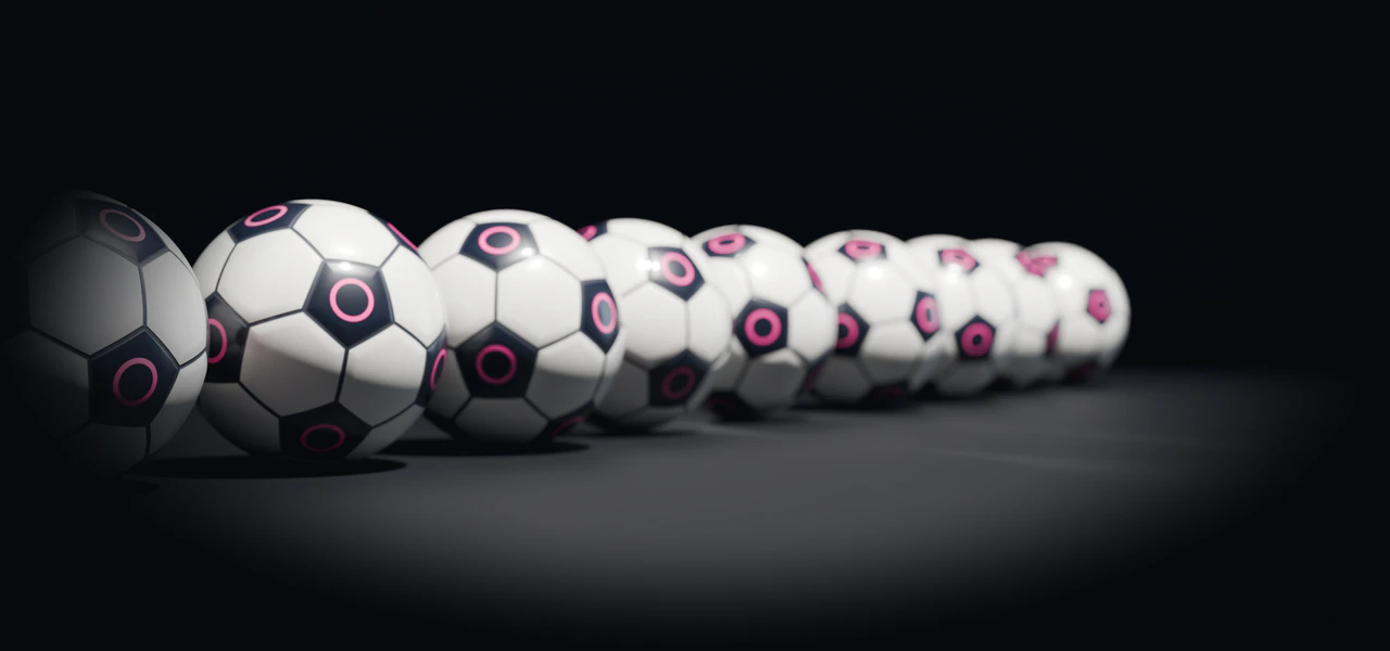 Ten Velarc Keel balls in a row on a dark studio floor